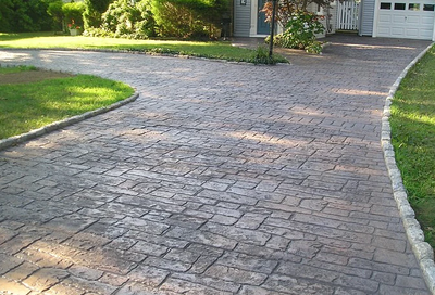 Old brick style pavement driveway of stamped concrete.