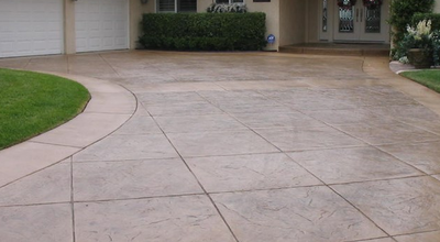 Large tile style textured and stamped concrete driveway.