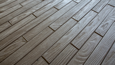 Interior concrete floor stamped with wood plank pattern.