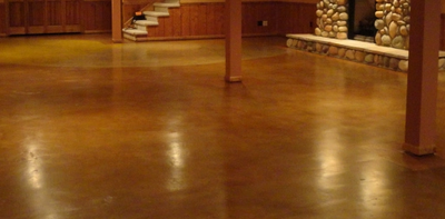 Stained and polished plain concrete basement floor.