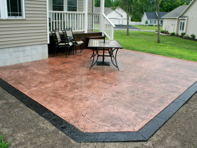 Stamped concrete patio with a dark brown stamped edging.