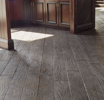 Wood grain finish stamped concrete kitchen floor.