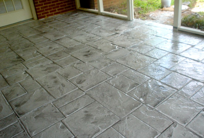 Stamped gray concrete indoor patio.