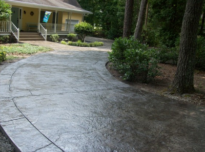 Long dark stained and textured concrete driveway in Danbury.